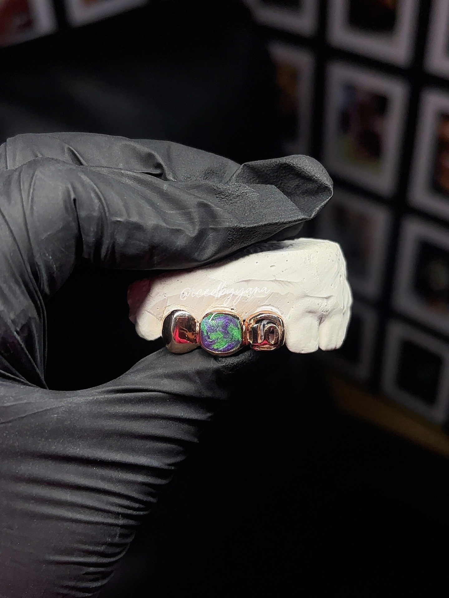Rose gold three-tooth grill with iridescent opal center on model