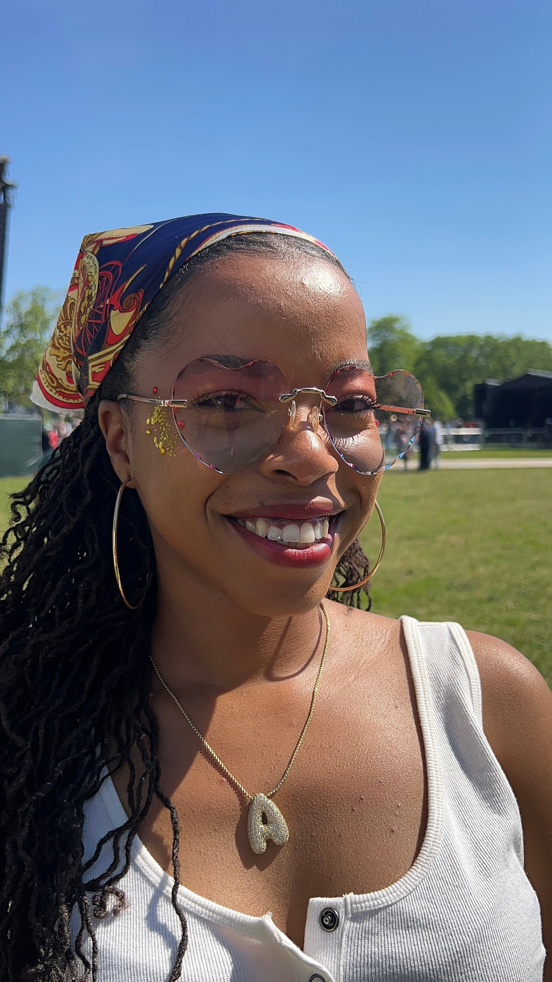 Heart-shaped sunglasses and a sparkling tooth gem
